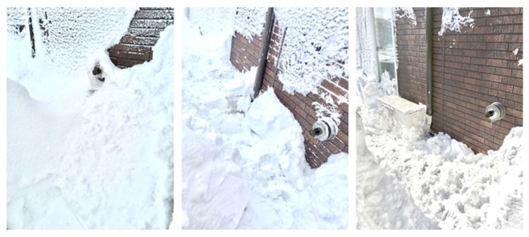 ストーブの排気口の周りの雪をかき分ける