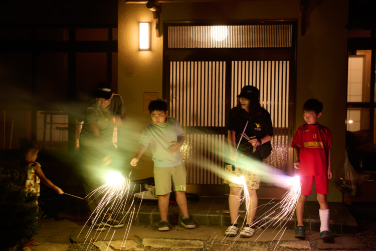 町内の寺で花火をする家族